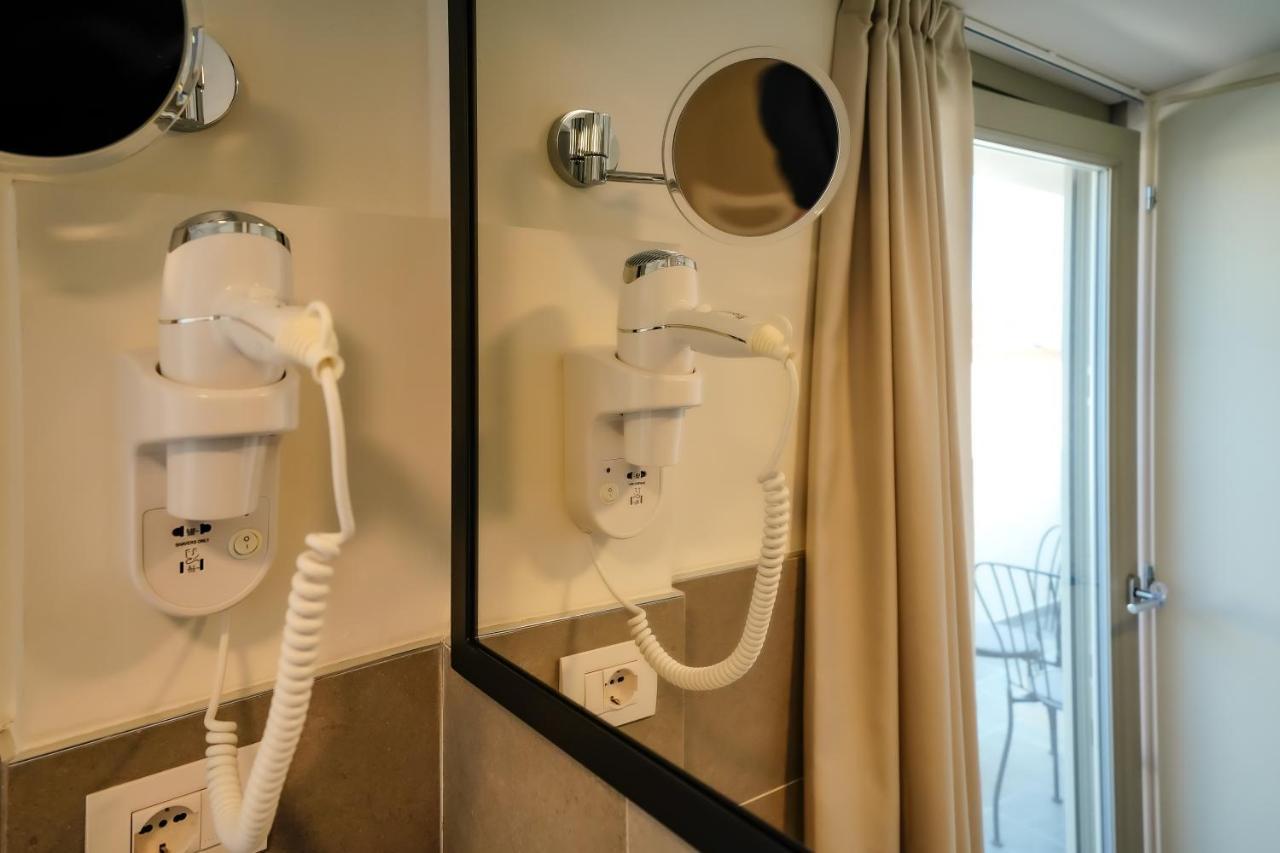 Bergamo Inn 15 Exterior foto A wall-mounted hair dryer in a hotel room